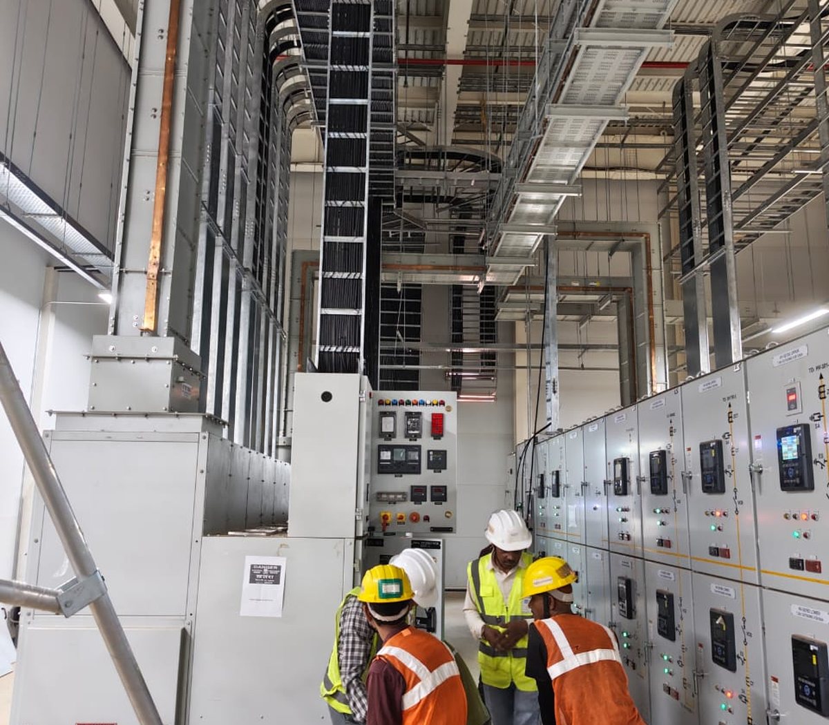 Engineers commissioning switchgear on site